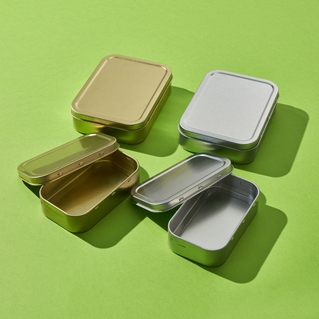 Silver and gold rectangular tins in two different sizes.