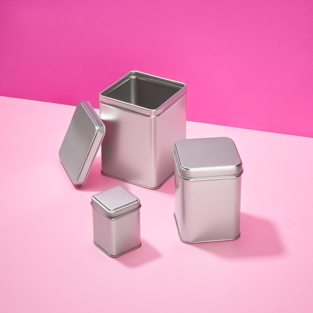 Tall square tin with slip lid in silver. Three sizes shown with the largest size open.