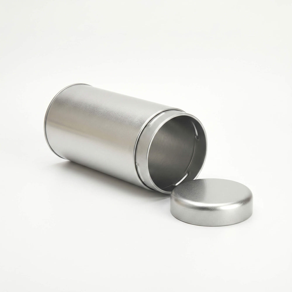 Open round silver tea tin with removable slip lid shown from side angle on white background.